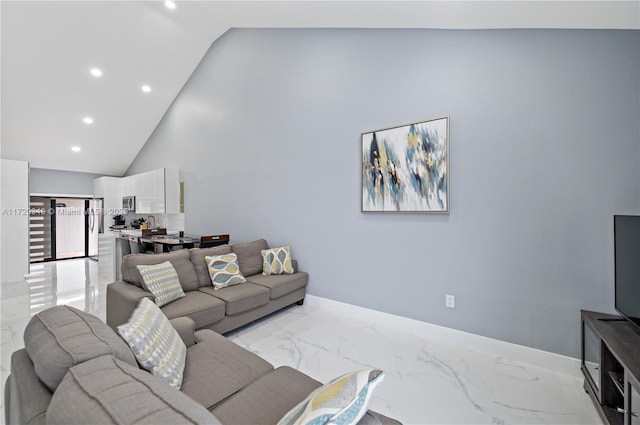 living room featuring high vaulted ceiling