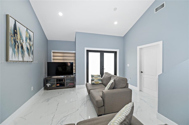 living room featuring lofted ceiling and french doors