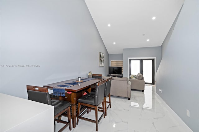 dining room featuring vaulted ceiling and french doors