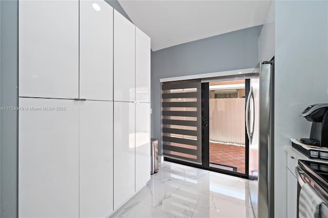 interior space with white cabinetry and stainless steel appliances