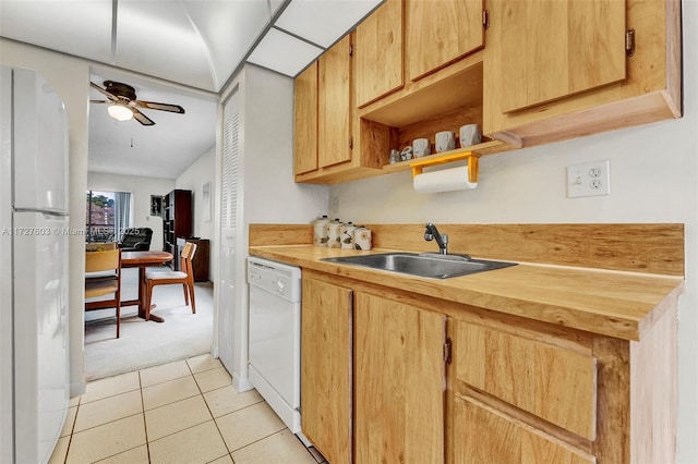 kitchen featuring white appliances, sink, light colored carpet, ceiling fan, and butcher block countertops