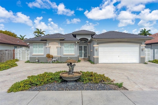 view of front of property featuring a garage and french doors