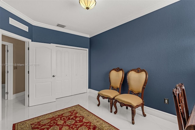 sitting room featuring tile patterned flooring and crown molding