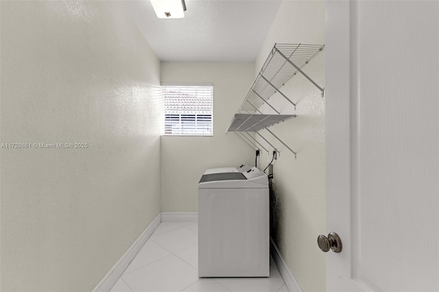 washroom with washing machine and dryer and light tile patterned floors