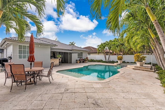 view of swimming pool featuring an in ground hot tub and a patio area