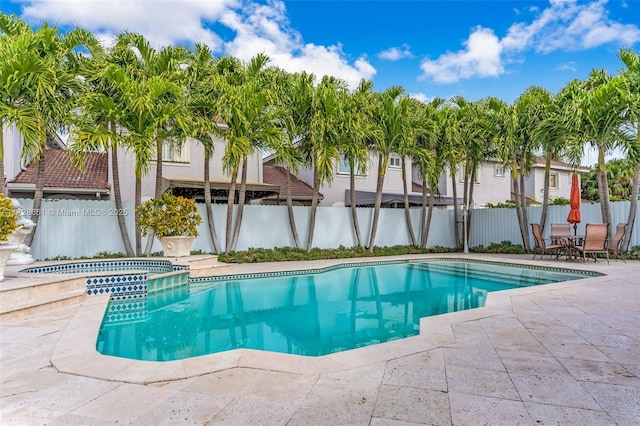 view of pool with an in ground hot tub and a patio