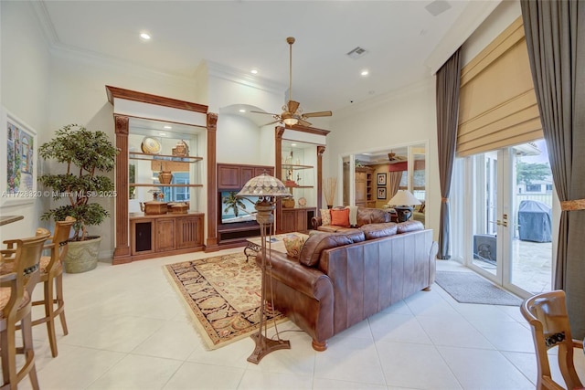 tiled living room with ornamental molding and ceiling fan