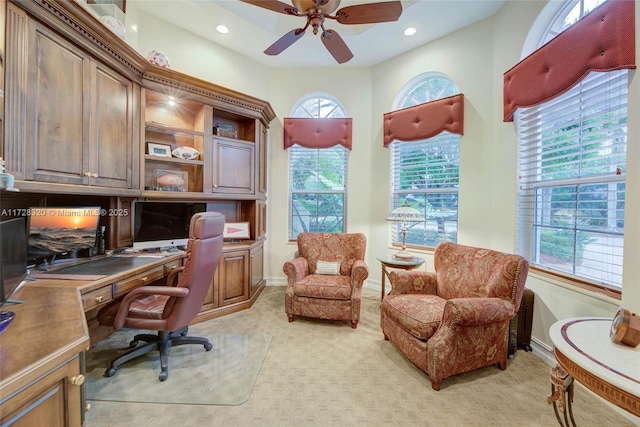 carpeted office featuring ceiling fan