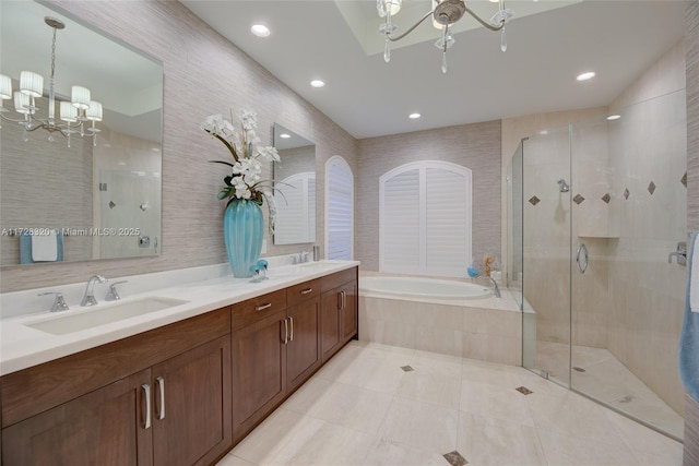 bathroom with tile walls, vanity, tile patterned floors, shower with separate bathtub, and a chandelier