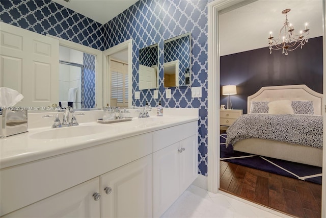 bathroom with tile patterned flooring, vanity, and a chandelier