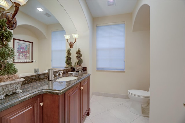 bathroom with vanity, toilet, and tile patterned flooring