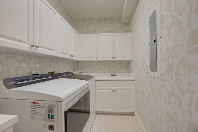 laundry area featuring light tile patterned floors, sink, washer and clothes dryer, electric panel, and cabinets