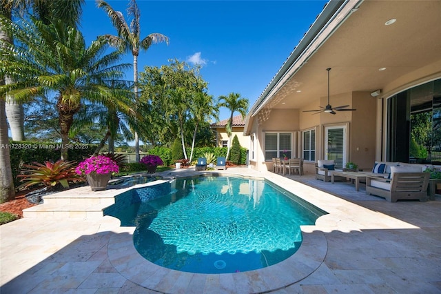 view of swimming pool featuring ceiling fan, an outdoor living space, and a patio