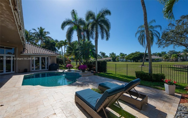 view of swimming pool with french doors, an in ground hot tub, and a patio