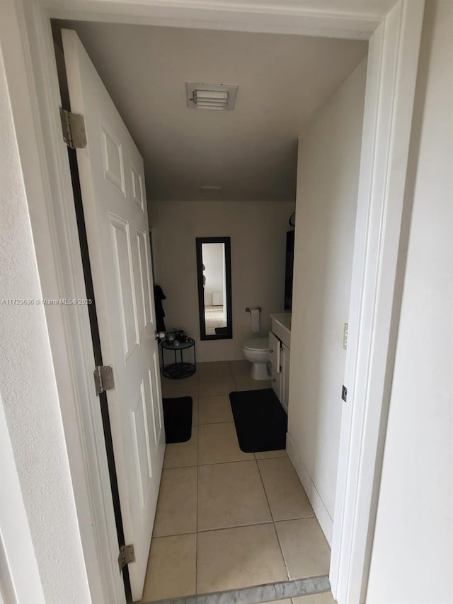 corridor with light tile patterned floors