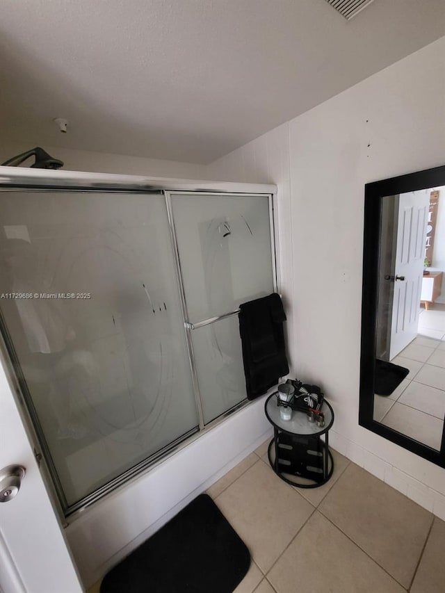 bathroom with enclosed tub / shower combo and tile patterned floors