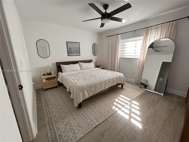 bedroom with ceiling fan and hardwood / wood-style floors