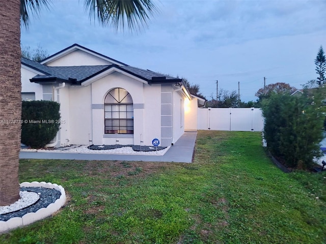 view of side of property with a lawn