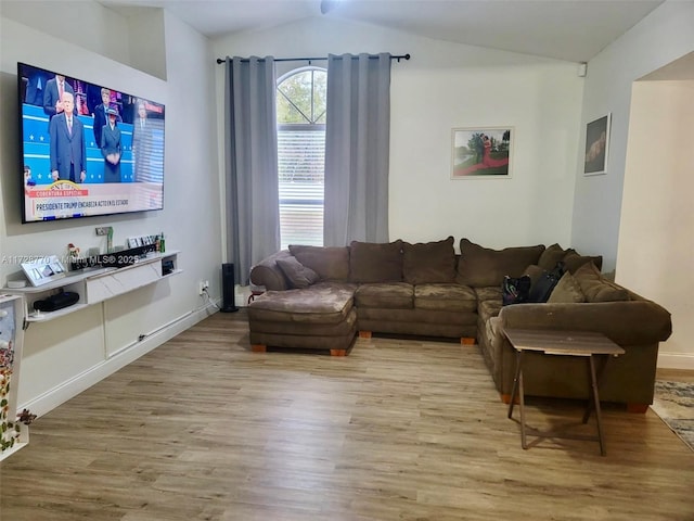 living room with lofted ceiling and light wood-type flooring