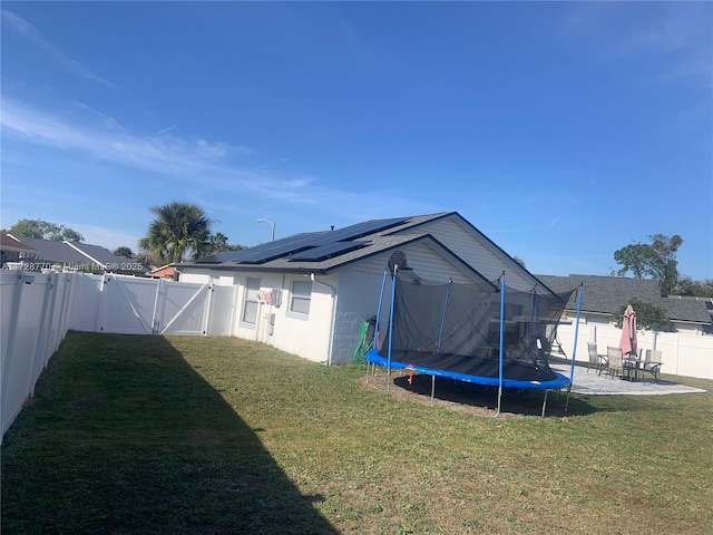 view of yard with a patio area and a trampoline