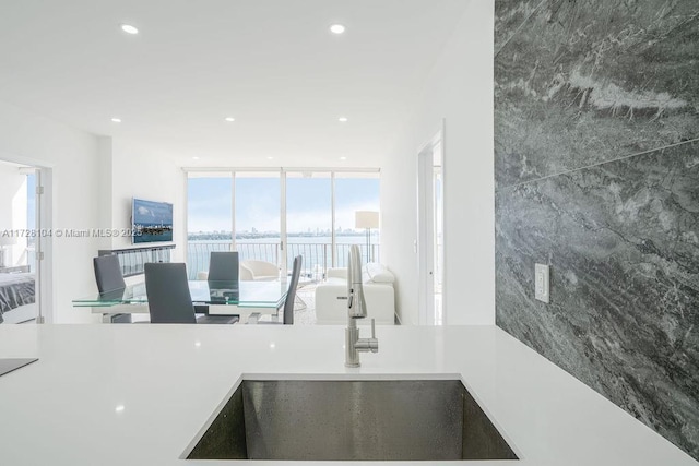 kitchen with a wall of windows and sink