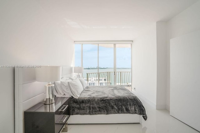 bedroom with a water view and access to outside