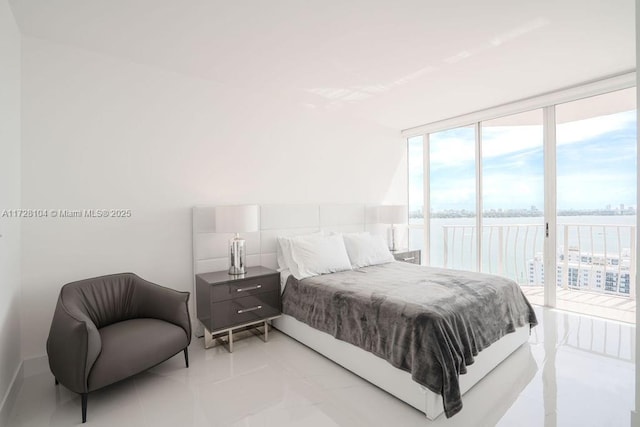 bedroom featuring floor to ceiling windows, access to exterior, and light tile patterned floors