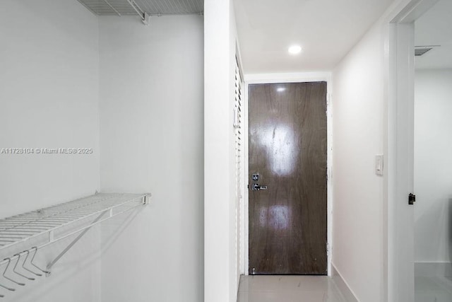 hall featuring light tile patterned floors