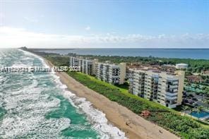 drone / aerial view with a water view and a view of the beach