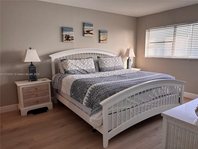 bedroom with hardwood / wood-style flooring