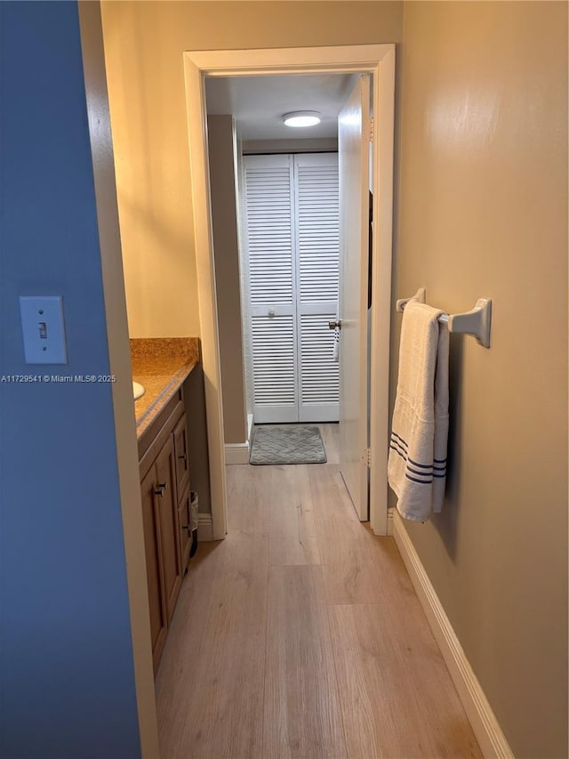 bathroom featuring wood-type flooring and vanity