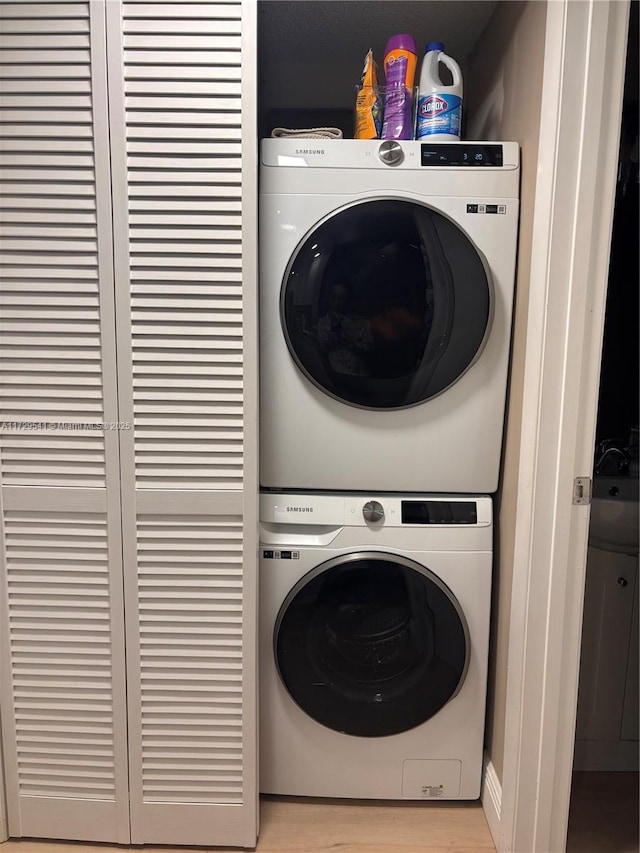 laundry area with stacked washer and clothes dryer