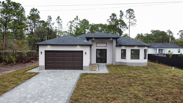 prairie-style home with a front lawn and a garage