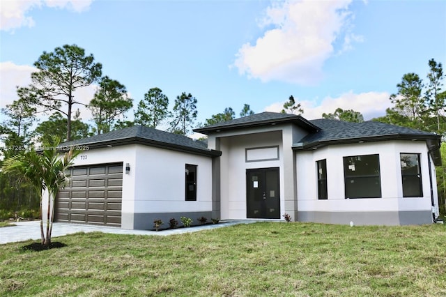 prairie-style house featuring a garage and a front lawn