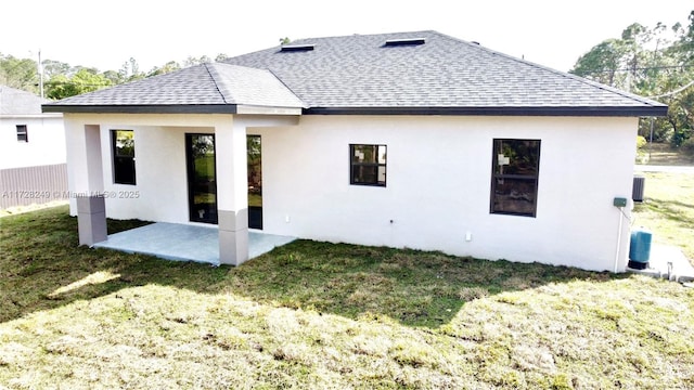 back of property with a patio and a lawn