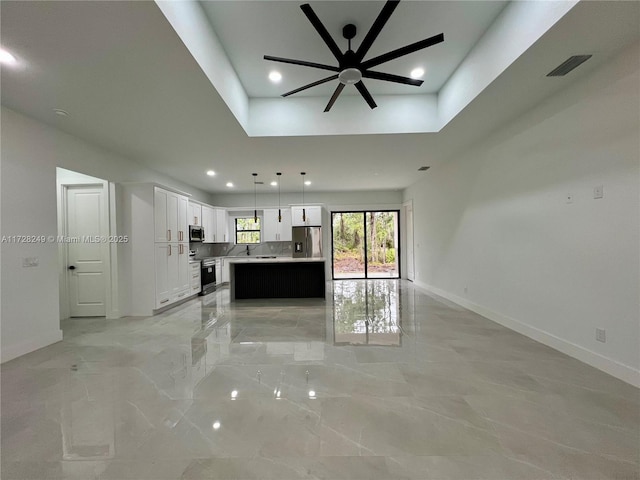 unfurnished living room featuring ceiling fan