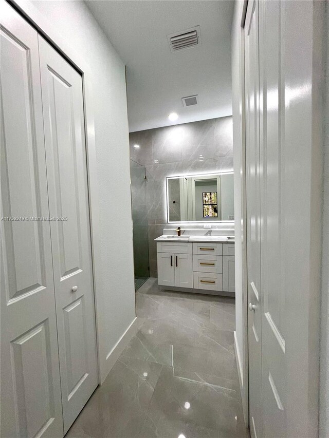 kitchen featuring ceiling fan, light stone countertops, hanging light fixtures, and white cabinets