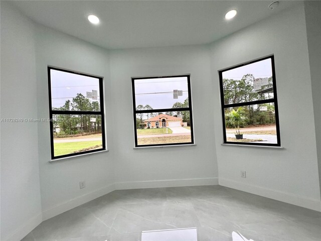 unfurnished room featuring a raised ceiling