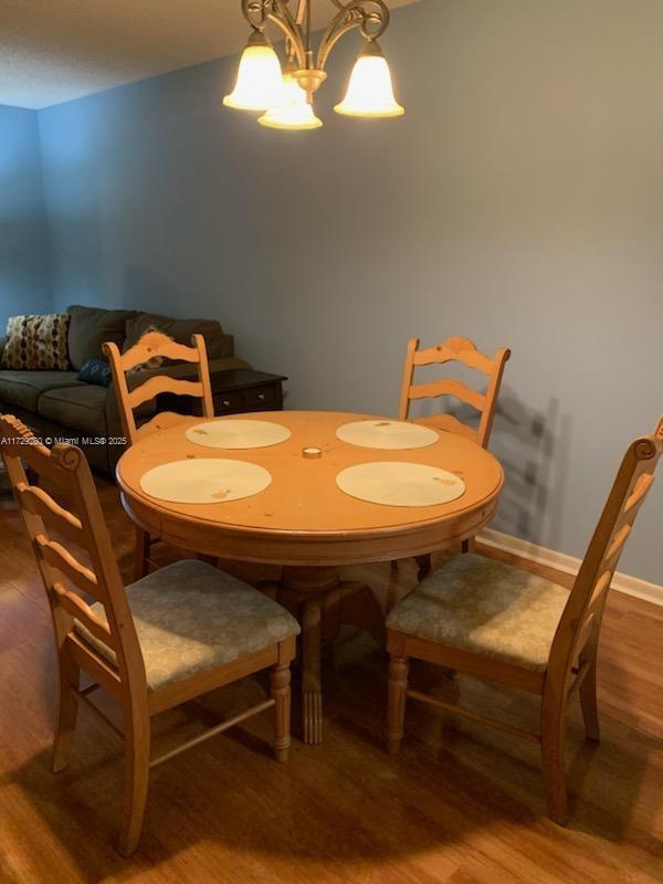 dining space featuring a chandelier and hardwood / wood-style flooring