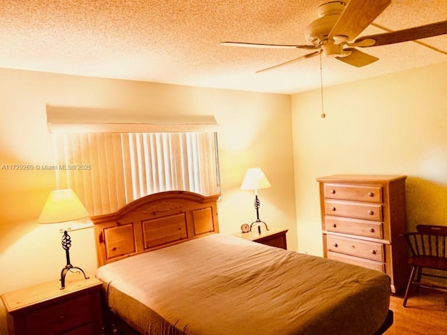 bedroom featuring a textured ceiling, ceiling fan, and hardwood / wood-style floors