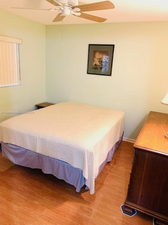 bedroom with ceiling fan and hardwood / wood-style floors