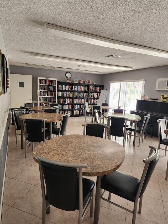 tiled dining area featuring a textured ceiling