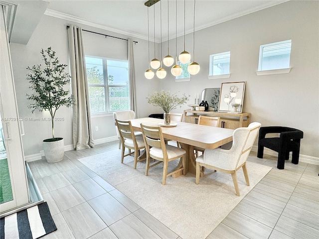 dining area featuring light tile patterned floors and crown molding