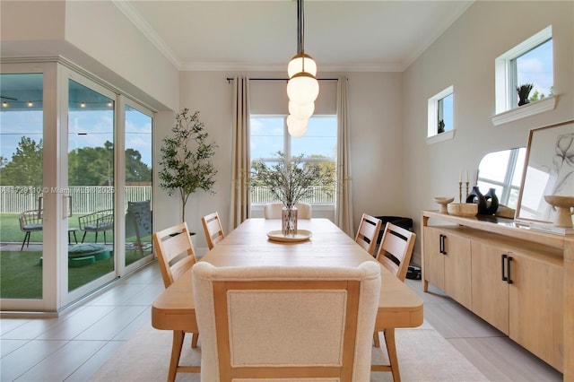 dining area featuring light tile patterned floors and ornamental molding