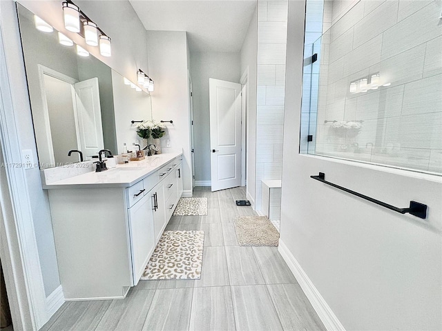 bathroom with vanity and a shower