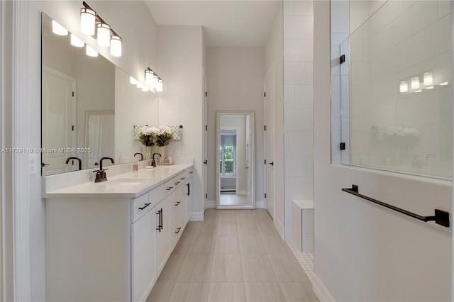 bathroom with a shower, tile patterned flooring, and vanity