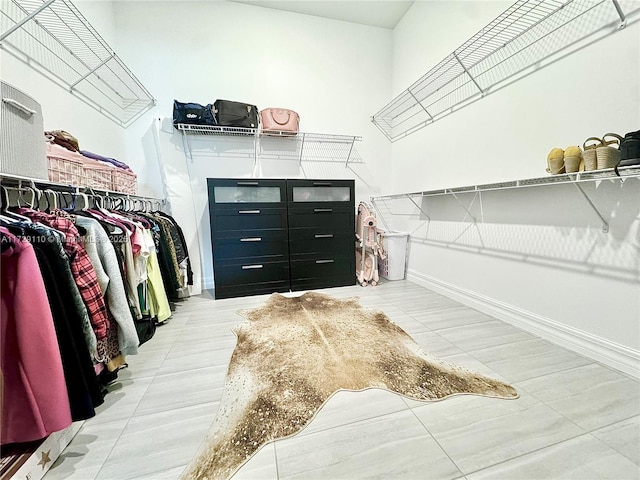 spacious closet with light tile patterned floors