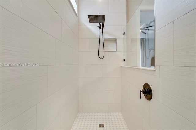 bathroom with a tile shower