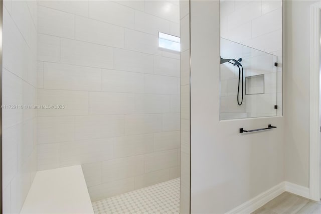 bathroom featuring a tile shower