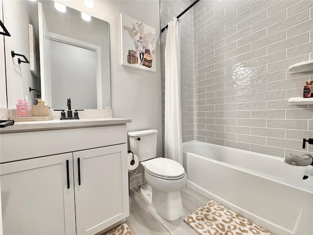 full bathroom featuring toilet, vanity, and shower / tub combo with curtain